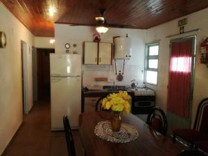 a kitchen with a table and a white refrigerator at Casa Marian in Federación