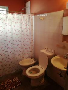 a bathroom with a toilet and a sink at Casa Marian in Federación