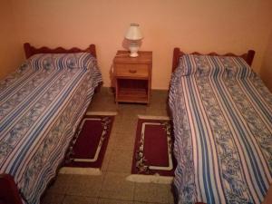 two beds sitting next to each other in a room at Casa Marian in Federación