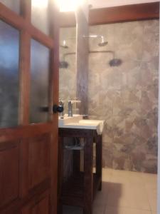 a bathroom with a sink and a mirror at Altos de la Pacha in Cafayate