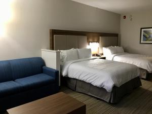 a hotel room with two beds and a couch at Holiday Inn Express - Grand Island, an IHG Hotel in Niagara Falls