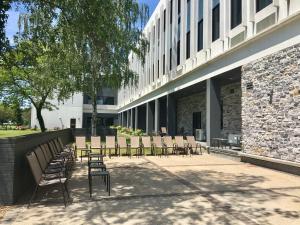 a group of chairs sitting outside of a building at Holiday Inn Express - Grand Island by IHG in Niagara Falls