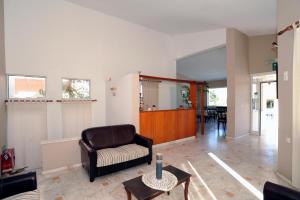 a living room with a chair and a table at Evilion hotel in Stalos