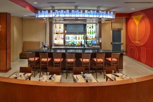 a restaurant with a bar and a bunch of chairs at Holiday Inn Jacksonville E 295 Baymeadows, an IHG Hotel in Jacksonville