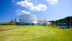a building with a grass field in front of a building at ANA Holiday Inn Resort Miyazaki, an IHG Hotel in Miyazaki