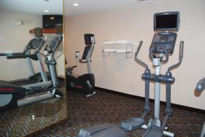a gym with tread machines and a phone in a room at Holiday Inn Express & Suites Hill City-Mt. Rushmore Area in Hill City