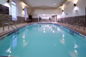 a large swimming pool with blue water at Holiday Inn Express & Suites Hill City-Mt. Rushmore Area in Hill City