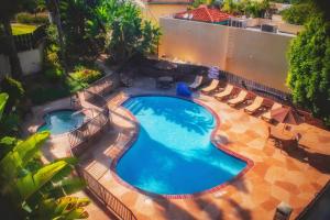 an overhead view of a swimming pool with lounge chairs at Holiday Inn Express Grover Beach-Pismo Beach Area, an IHG Hotel in Grover Beach