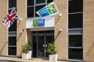 a building with two flags in front of it at Holiday Inn Express London - Watford Junction by IHG in Watford