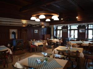 a dining room with tables and chairs and a chandelier at Gaberlhaus in Salla