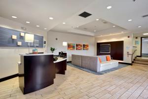 a hospital lobby with a reception desk and a couch at Holiday Inn Express Costa Mesa, an IHG Hotel in Costa Mesa