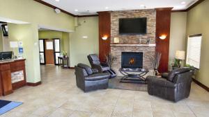 a lobby with two chairs and a fireplace at Holiday Inn Express Jamestown, an IHG Hotel in Jamestown