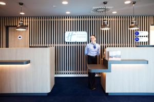 a man is standing in a room with at Holiday Inn Express - Ringsheim by IHG in Ringsheim +56 photos