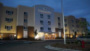 a hotel building with a car parked in a parking lot at Candlewood Suites Midland, an IHG Hotel in Midland