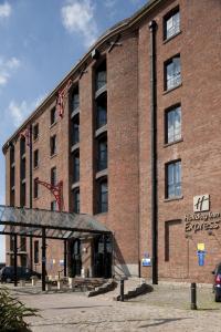 
a brick building with a sign on the side of it at Holiday Inn Express Liverpool-Albert Dock, an IHG Hotel in Liverpool
