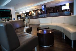 a living room filled with furniture and a tv at Holiday Inn Express London Stratford, an IHG Hotel in London