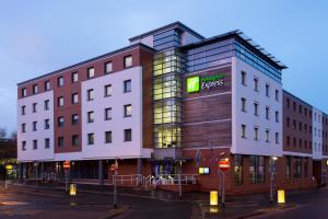a building with a sign on the side of it at Holiday Inn Express Harlow, an IHG Hotel in Harlow