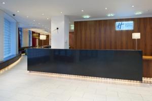 a lobby with a reception desk in a building at Holiday Inn Express London City, an IHG Hotel in London
