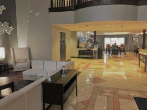 a living room with a couch and a table at Holiday Inn Express Hotel & Suites Laurinburg by IHG in Laurinburg