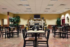 a restaurant with tables and chairs and a fireplace at Holiday Inn Express of Salado-Belton by IHG in Salado