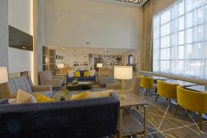 a lobby with couches and chairs and a large window at Staybridge Suites - Little Rock - Medical Center by IHG in Little Rock