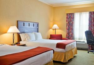 a hotel room with two beds and a chair at Holiday Inn Express of Salado-Belton by IHG in Salado +22 photos