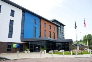 a large building with a blue at Holiday Inn Express Dunstable by IHG in Dunstable