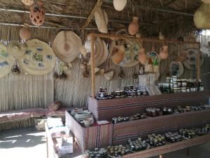 a store with hats and other items on a wall at Basmat almisfah in Al Ḩamrāʼ