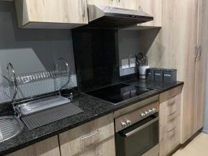 a kitchen with a sink and a counter top at Durban Waterfront Apartments in Durban