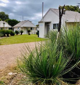 a house with some plants in front of a yard at Esperance Coastal Retreat in Esperance