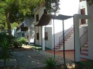 a building with stairs on the side of it at Menorca Bonavista in Cala Galdana