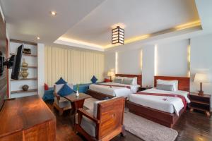Postel nebo postele na pokoji v ubytování King Rock Boutique Hotel