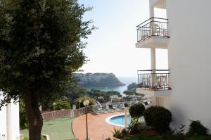 a view of the ocean from the balcony of a building at Menorca Bonavista in Cala Galdana