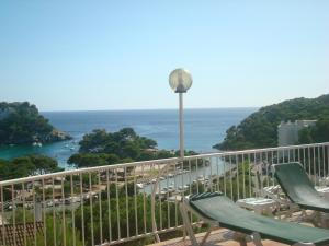 a balcony with chairs and a view of the ocean at Menorca Bonavista in Cala Galdana