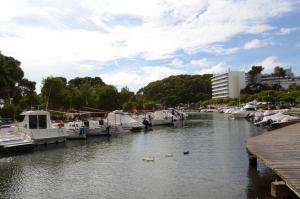 a marina with boats and ducks in the water at Menorca Bonavista in Cala Galdana