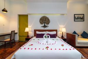 Postel nebo postele na pokoji v ubytování King Rock Boutique Hotel