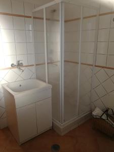 a white bathroom with a shower and a sink at Le Carcare in Santo Stefano del Sole +7 photos