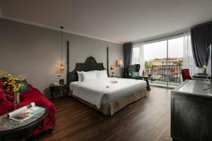 a hotel room with a bed and a balcony at Shining Central Hotel & Spa in Hanoi