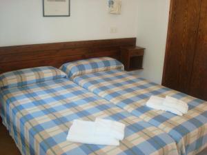 a bedroom with two beds with towels on them at Menorca Bonavista in Cala Galdana