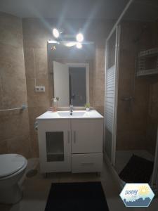 a bathroom with a sink and a shower and a toilet at Sunny Torremolinos Centro in Torremolinos