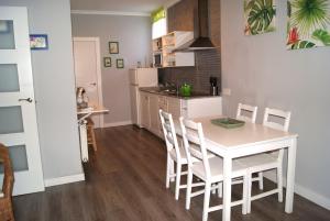 a kitchen and dining room with a white table and chairs at Puerta de Alcaraz in Alcaraz