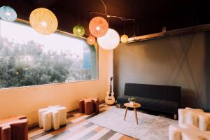 a living room with a couch and a guitar at Uno Backpackers Inn in Kaohsiung