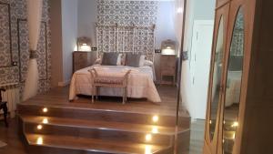 a bedroom with a bed with a table and a glass door at Puerta de Alcaraz in Alcaraz