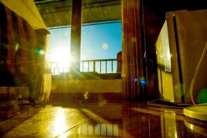 a sun shining through a window in a room at Senasuma Homestay in Ella