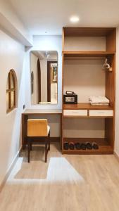 a dressing room with a mirror and a chair at Big Tree Old Town Hotel in Chiang Mai