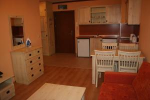 a kitchen with a table and chairs in a room at Saint Ivan Ski Apartments in Bansko