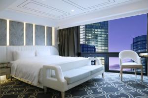 Ένα ή περισσότερα κρεβάτια σε δωμάτιο στο Nanjing Central Hotel