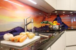 a kitchen counter with fruits and vegetables on a cutting board at Appartement au centre de Zermatt (4-8 personnes) in Zermatt
