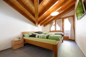um quarto com uma cama e um tecto de madeira em Appartement au centre de Zermatt (4-8 personnes) em Zermatt