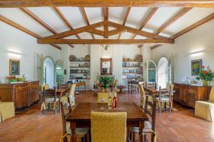 a dining room with wooden tables and chairs at Wine Resort Ledà d'Ittiri in Alghero